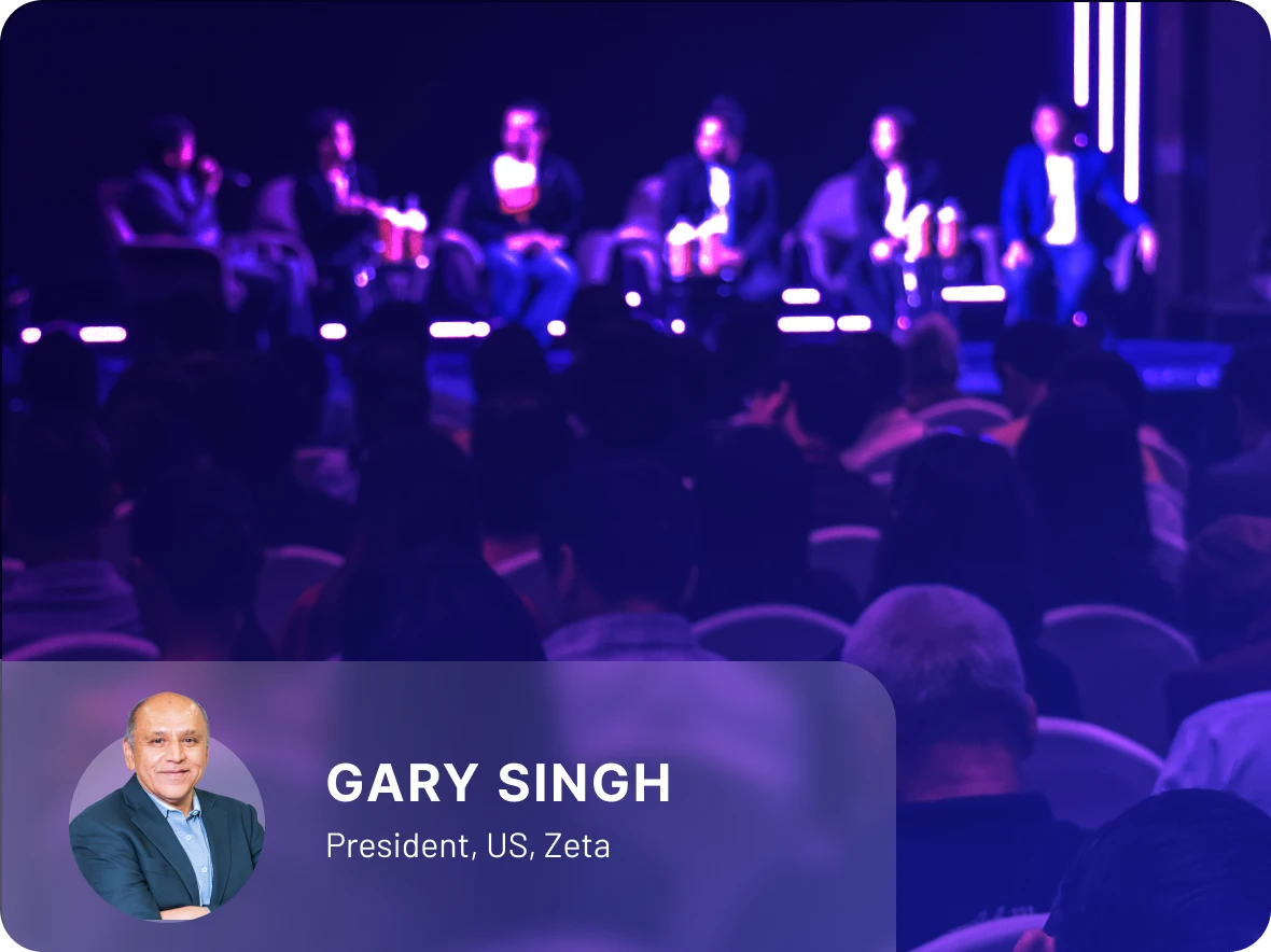 The image shows Gary Singh, President of Zeta US, joins a panel moderated by Jonah Crane from Klaros Group at CBA Live conference 2025 to explore the future of Banking as a Service (BaaS) and how issuers can enhance customer experiences with innovation while ensuring compliance.